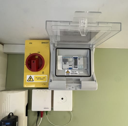 The grand total of the solar equipment installed inside our office, tucked out of the way in a top corner. Yellow Box = PV System Isolator, Grey Box = Solar PV Distribution Board