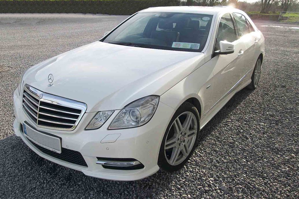A white two seater Mercedes E Class luxury saloon car for private tours of Ireland.