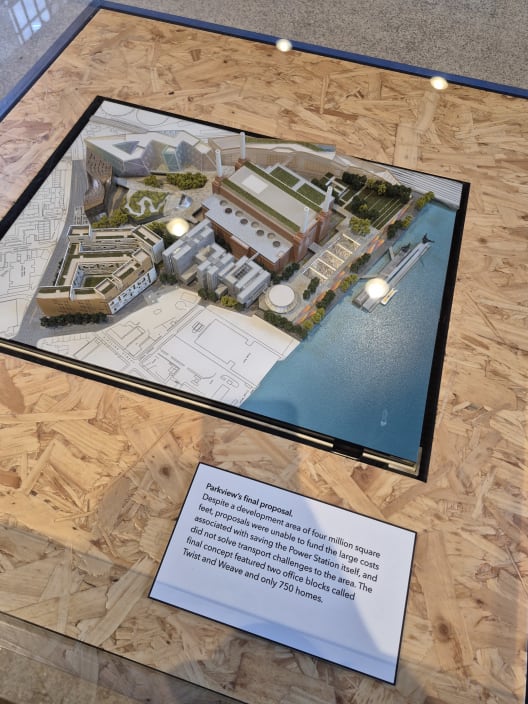 A miniature architectural model of Battersea Power Station and the surrounding riverside, displayed on an exhibit table.
