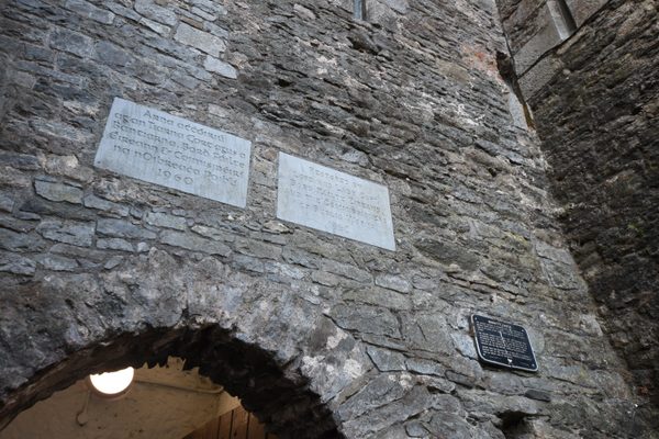 Two carved stone plaques set into the rough stonework above the archway at Bunratty Castle