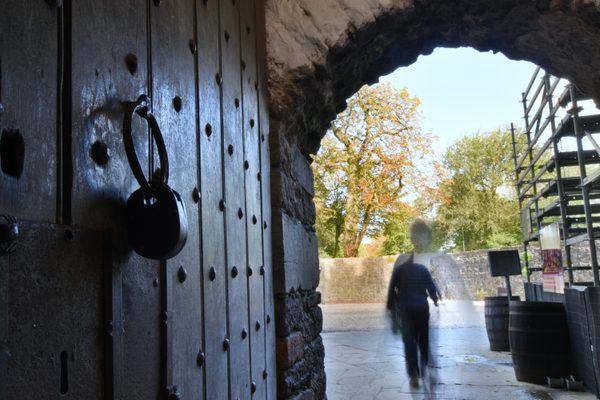 Looking out through the studded wooden door and stone archway of Bunratty Castle