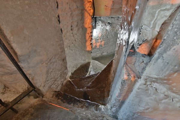 The narrow turning stone stair inside Bunratty Castle, lit from a narrow window