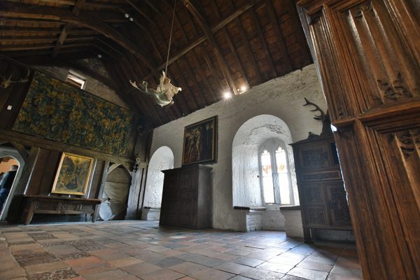 The vaulted stonework, timber roof and wall paintings inside Bunratty Castle