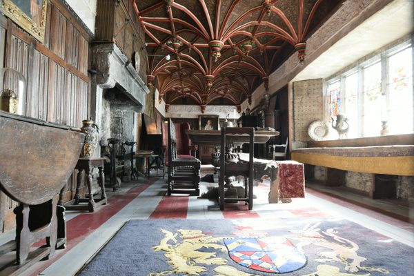 Inside the South Solar at Bunratty Castle, with its carved timber ceiling, heraldic carpet and long table lit by mullioned windows