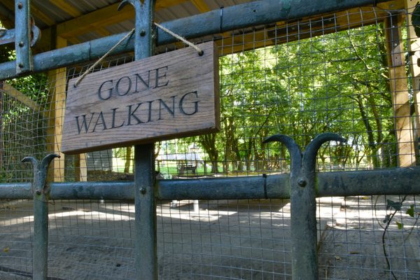 A hand-painted Gone Walking sign on a fence at Bunratty Folk Park