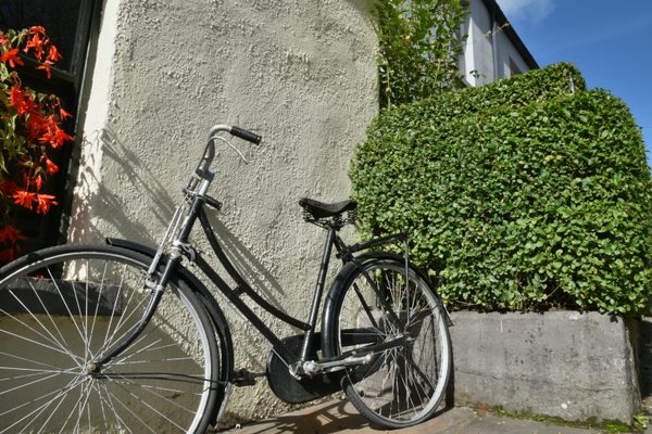 A vintage bicycle leaning against a stone wall at Bunratty Folk Park