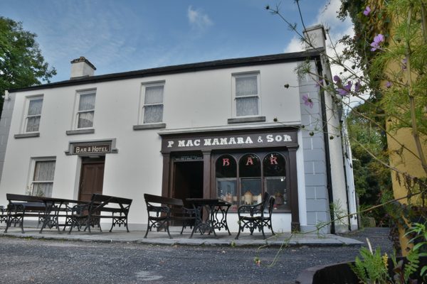The pub front on Main Street at Bunratty Folk Park, with tables and benches outside