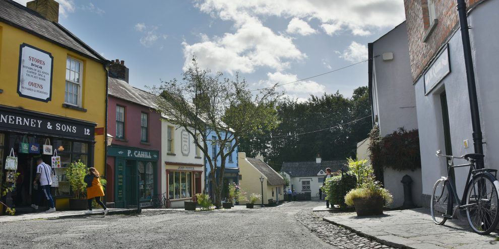 Looking down Main Street at Bunratty Folk Park, past its painted shopfronts