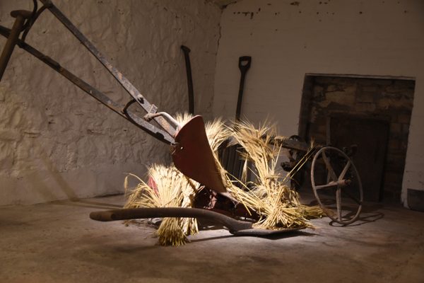 A vintage horse-drawn plough and farm implements on display at Midleton Distillery Experience