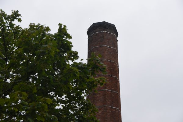 The tall brick chimney of the distillery, seen from below
