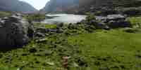 The Gap of Dunloe with an old bridge and walkers. 