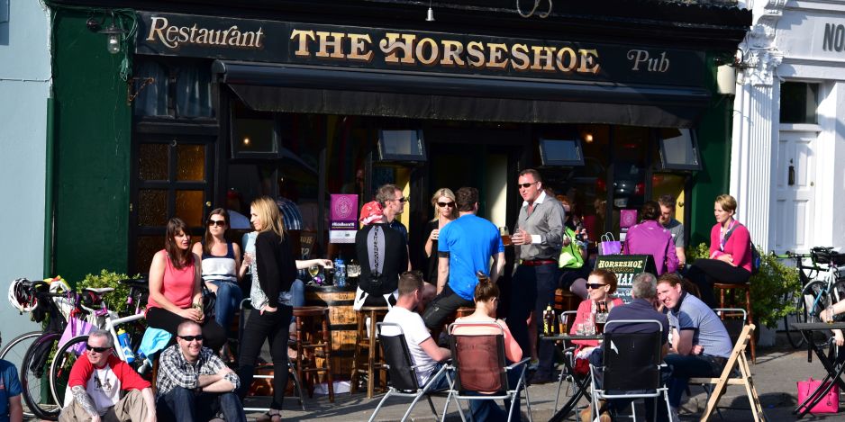 People gathering in the sun at a pub in Kenmare