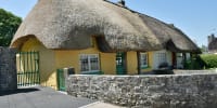 The thatched cottages lining the main street of Adare, County Limerick